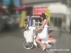 Asian teen doll getting pussy wet while riding the bike